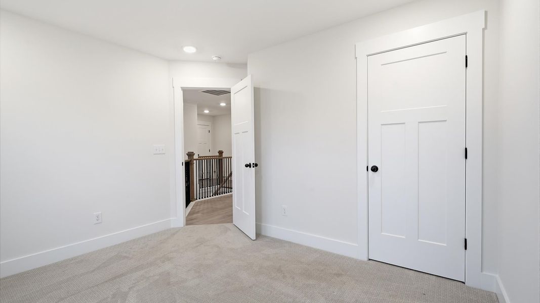 Accomplished design shines in this carpeted bedroom with a functional walk-in closet in Spartanburg, SC