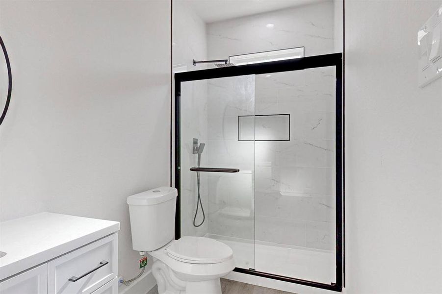 Bathroom featuring vanity and a marble finish shower Bathroom featuring vanity and a marble finish shower