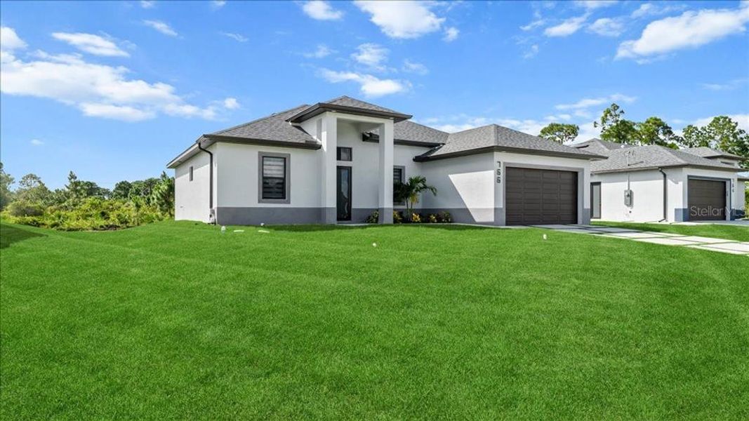 Front exterior of a new home in , Lehigh Acres, FL, highlighting curb appeal (Image 27).