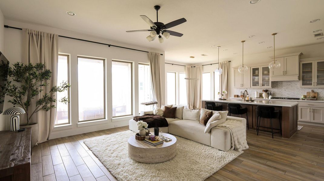 An inviting open-concept living area with a bright kitchen and comfortable lounge space. An inviting open-concept living area with a bright kitchen and comfortable lounge space.