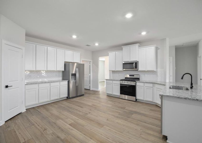 Chef ready kitchen with white cabinets and stainless steel appliances