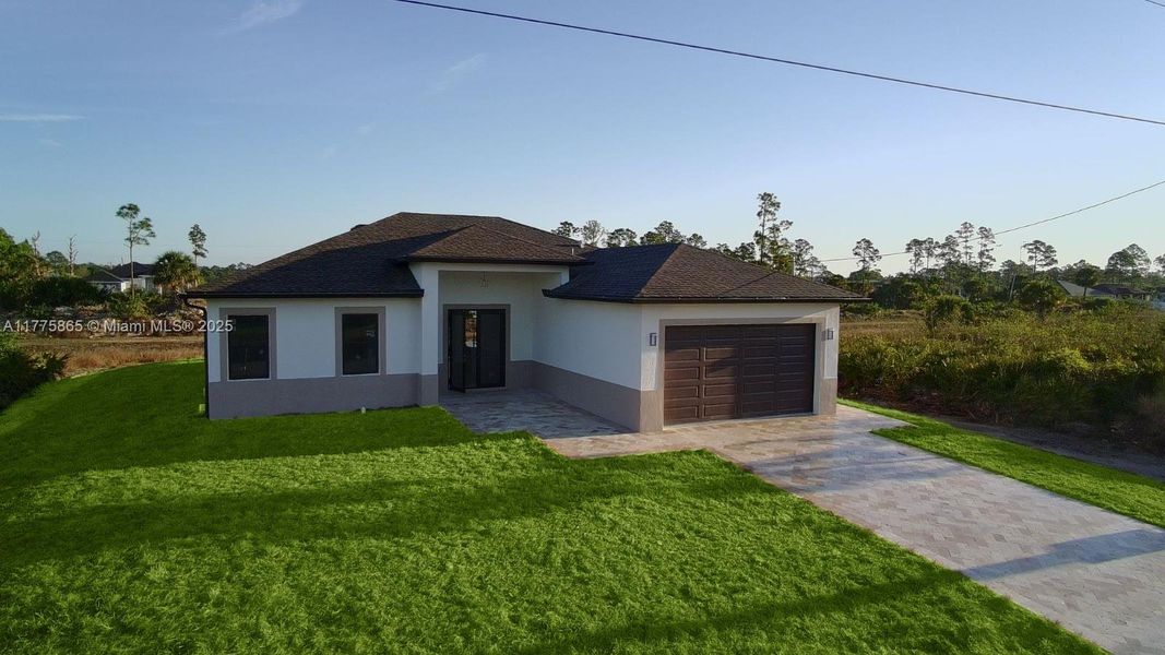 Front exterior of a new home in , Lehigh Acres, FL, highlighting curb appeal (Image 2).