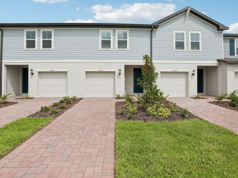 Front exterior of a new home in Cagan Crossings West, Clermont, FL, highlighting curb appeal (Image 1). Front exterior of a new home in Cagan Crossings West, Clermont, FL, highlighting curb appeal (Image 1).