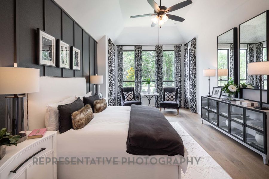 Bedroom with light wood-type flooring and vaulted ceiling Bedroom with light wood-type flooring and vaulted ceiling