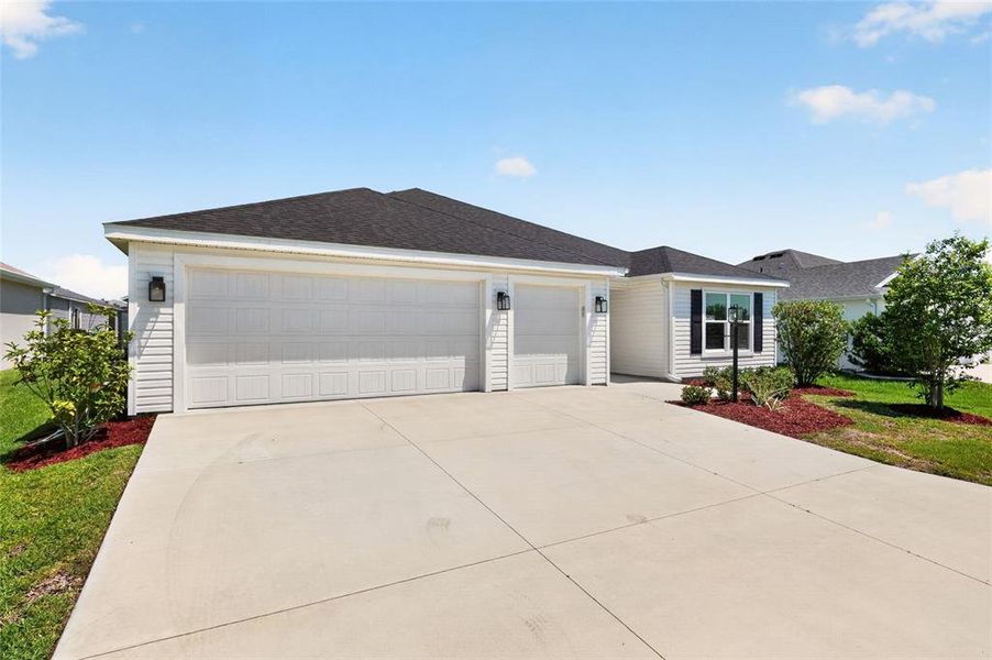 Front exterior of a new home in , The Villages, FL, highlighting curb appeal (Image 26).