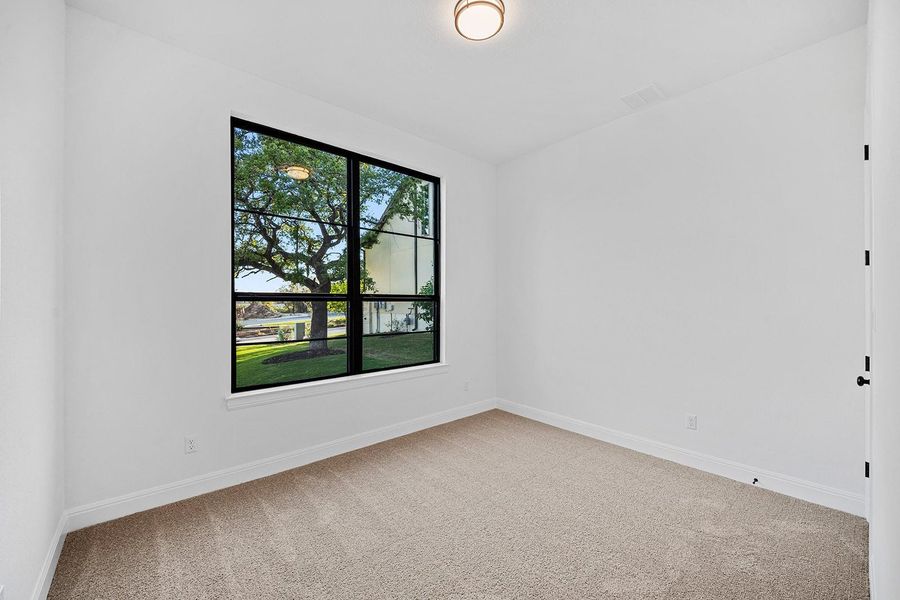 Carpeted spare room featuring baseboards Carpeted spare room featuring baseboards