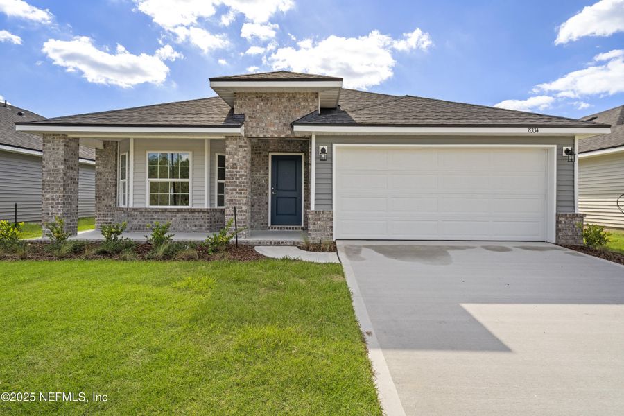 Front exterior of a new home in Summerglen, Jacksonville, FL, highlighting curb appeal (Image 1).
