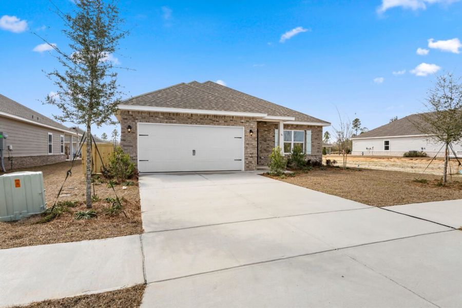 Front exterior of a new home in Natureview, Freeport, FL, highlighting curb appeal (Image 2). Front exterior of a new home in Natureview, Freeport, FL, highlighting curb appeal (Image 2).