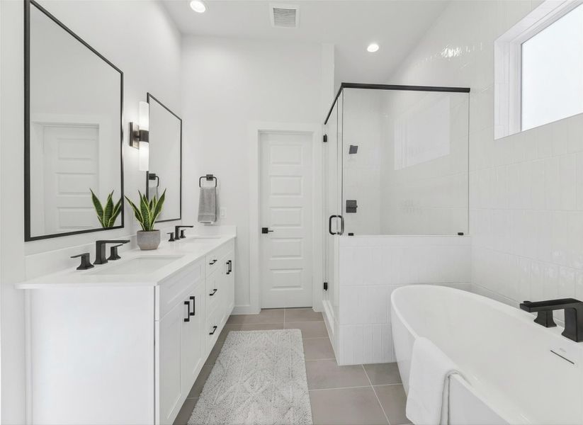 View from the primary closet into the bathroom highlights the dual sinks and spacious layout, emphasizing the functional and luxurious design of the primary suite. *Virtually staged*