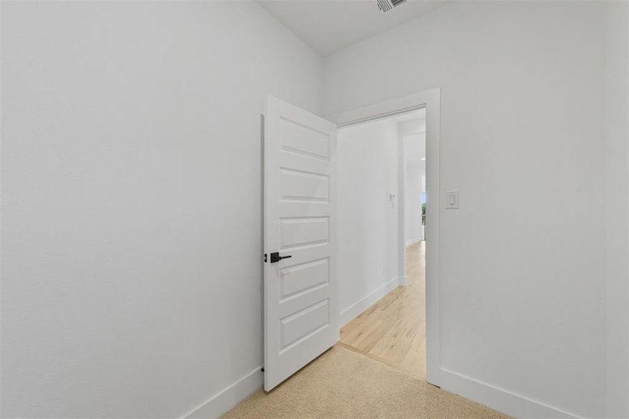 Spare room featuring baseboards and light colored carpet