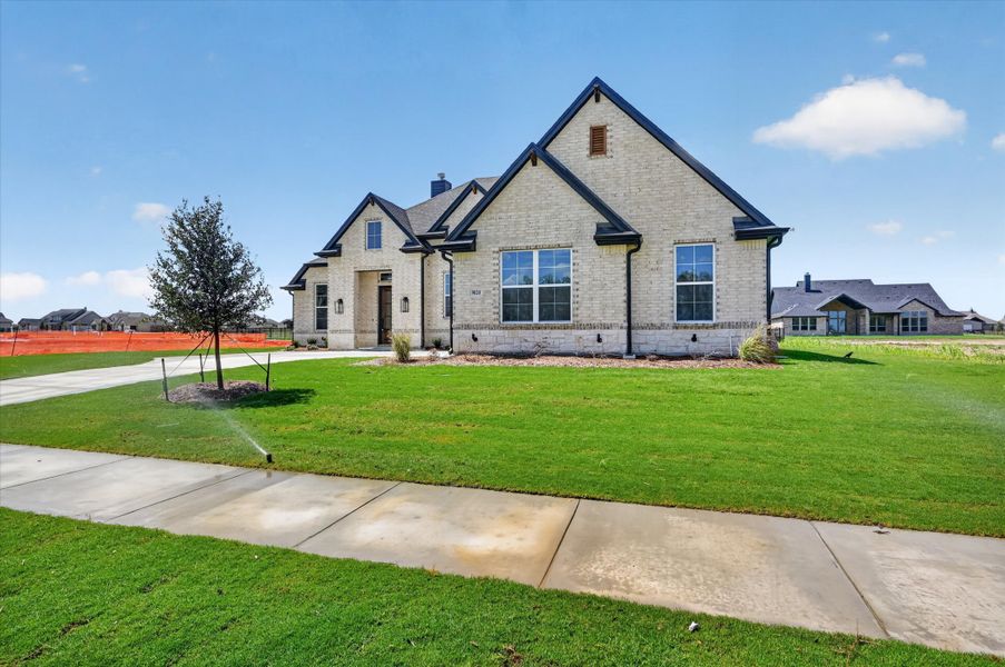 Front exterior of a new home in Paloma Ranches, Justin, TX, highlighting curb appeal (Image 24).