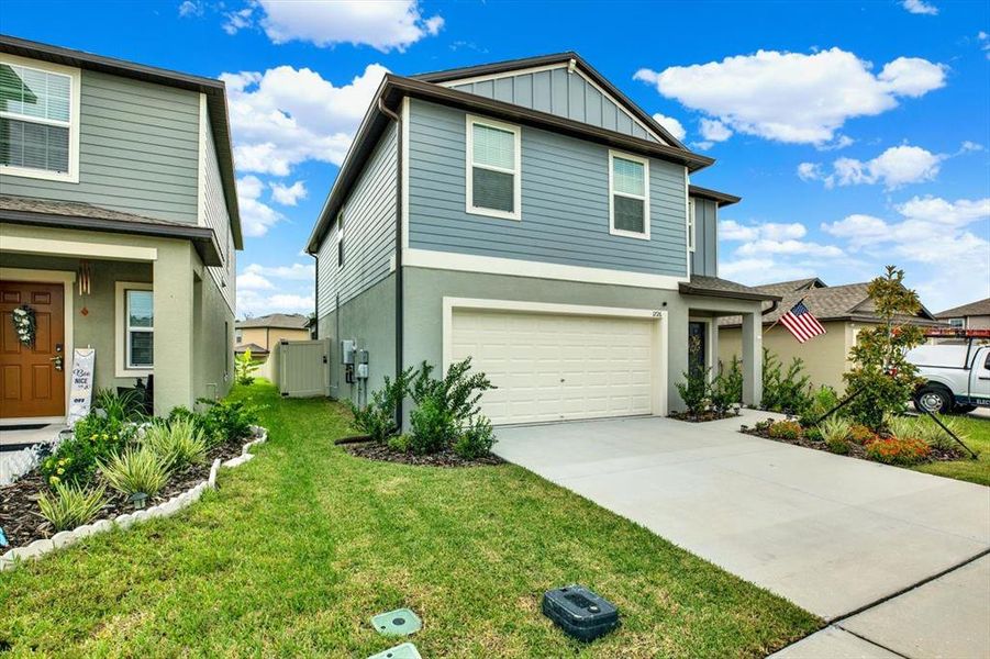 Front exterior of a new home in Two Rivers: The Manors II, Zephyrhills, FL, highlighting curb appeal (Image 27). Front exterior of a new home in Two Rivers: The Manors II, Zephyrhills, FL, highlighting curb appeal (Image 27).