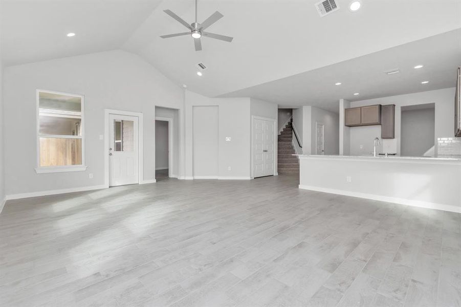 Another view of the expansive family room. Sample photo of completed home with similar floor plan. As-built interior colors and selections may vary.