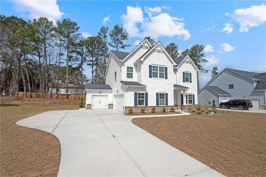 Front exterior of a new home in Stephen's Landing, Loganville, GA, highlighting curb appeal (Image 1). Front exterior of a new home in Stephen's Landing, Loganville, GA, highlighting curb appeal (Image 1).