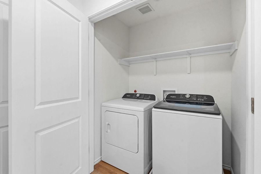 Dedicated laundry closet featuring a top-load washer and front-load dryer Dedicated laundry closet featuring a top-load washer and front-load dryer