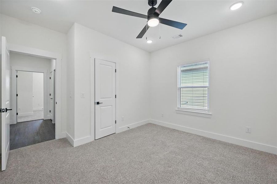 Unfurnished bedroom featuring carpet, a ceiling fan, baseboards, visible vents, and recessed lighting Unfurnished bedroom featuring carpet, a ceiling fan, baseboards, visible vents, and recessed lighting