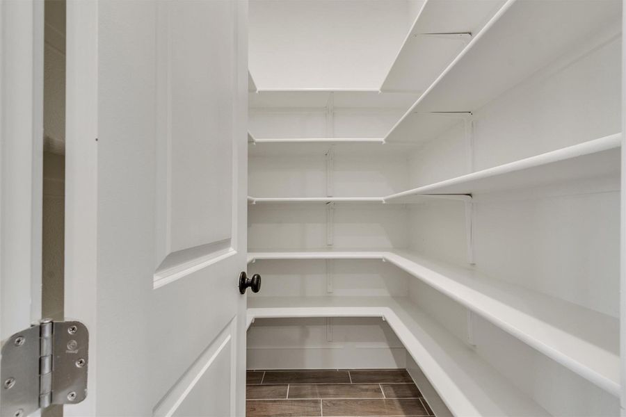 Ample built-in shelving and easy-care tile flooring define this practical pantry.