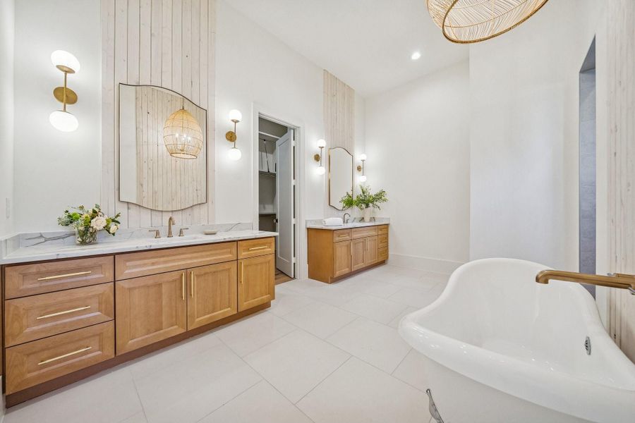 The primary bathroom is luxuriously appointed from the clawfoot tub to the extended walk-in shower behind the tub wall. The closet is amazing and even has a hidden closet.