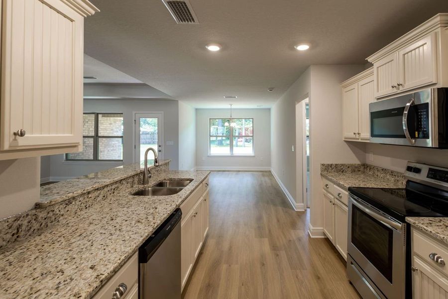 Representative furnished interior of a home built from the 2005 by Adams Homes in Parkland Place, Pace (Image 4).