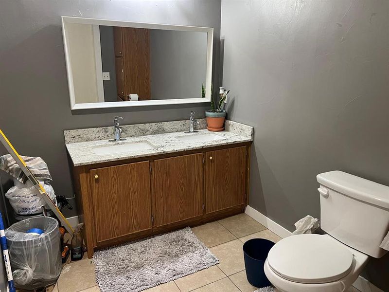 Bathroom featuring tile patterned flooring, vanity, and toilet