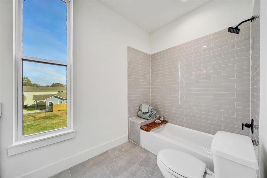 This photo was taken in another staged property with the same finishes and layout. Secondary shower/tub combo.