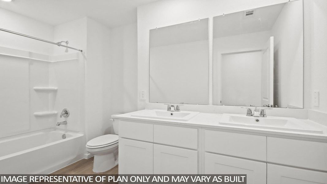Bathroom featuring a dual vanity with white cabinetry, white countertops, and undermount sinks