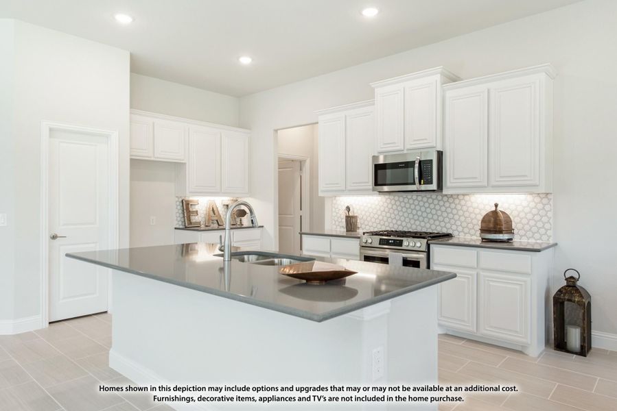 Kitchen with white cabinets, gray island with sink, stainless steel appliances, and hexagon tile backsplash Kitchen with white cabinets, gray island with sink, stainless steel appliances, and hexagon tile backsplash