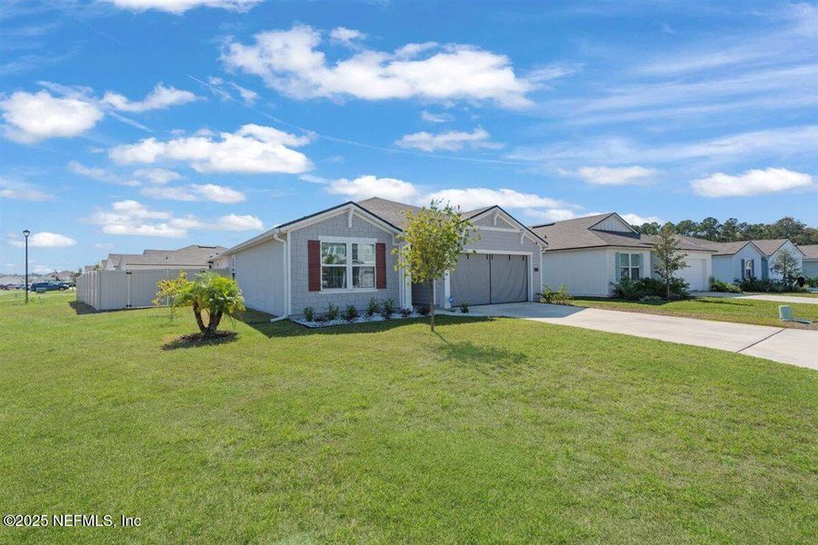 Front exterior of a new home in Dorado at Entrada, St. Augustine, FL, highlighting curb appeal (Image 2). Front exterior of a new home in Dorado at Entrada, St. Augustine, FL, highlighting curb appeal (Image 2).