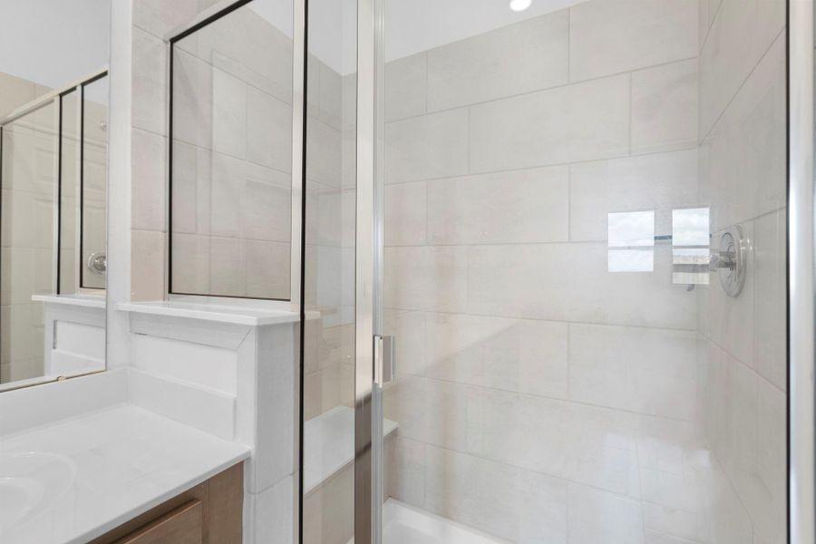 This additional view of your primary bathroom features tile flooring, fresh paint, and large walk-in shower. This additional view of your primary bathroom features tile flooring, fresh paint, and large walk-in shower.