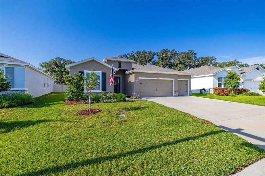 Front exterior of a new home in Farm at Varrea, Plant City, FL, highlighting curb appeal (Image 25). Front exterior of a new home in Farm at Varrea, Plant City, FL, highlighting curb appeal (Image 25).