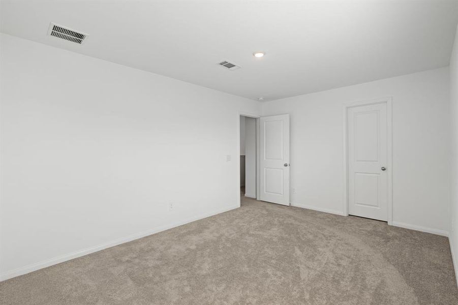 Another view of the Serene Secondary bedroom featuring plush carpet, oversized window and walk-in closet for added storage.