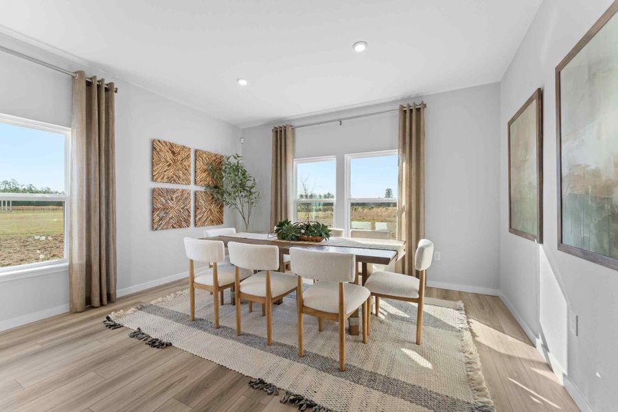 A dining room with a large window.