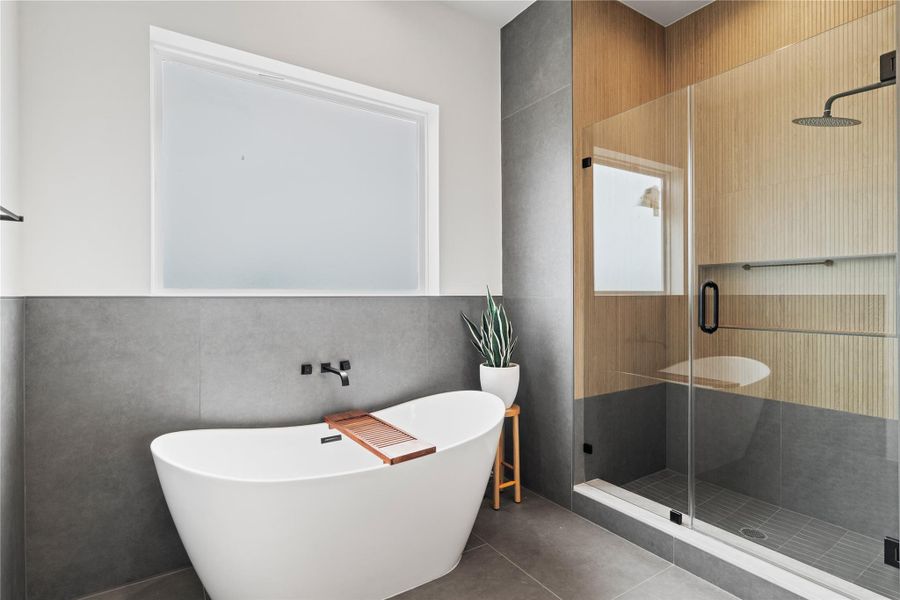 Relax or take a peaceful cold plunge in your soaking tub with large privacy glass, or enjoy the elegant shower with tile extending to the ceiling for a spa-like escape. Relax or take a peaceful cold plunge in your soaking tub with large privacy glass, or enjoy the elegant shower with tile extending to the ceiling for a spa-like escape.