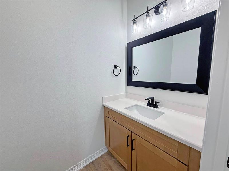 Bathroom with vanity and light wood finished floors