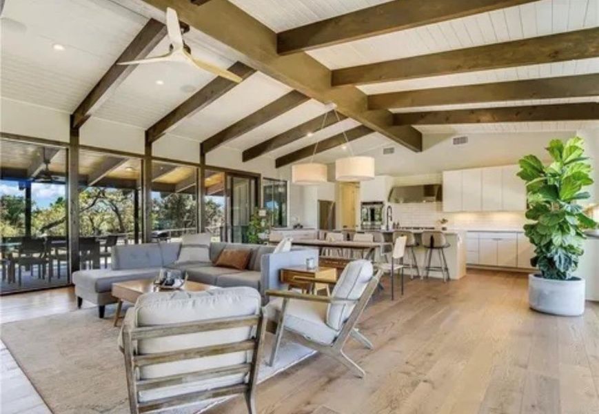 Living area featuring light wood-style floors and ceiling fan Living area featuring light wood-style floors and ceiling fan