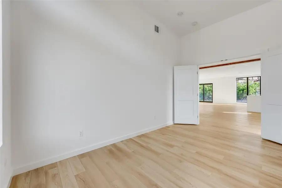 Empty room with light wood-style floors and baseboards Empty room with light wood-style floors and baseboards