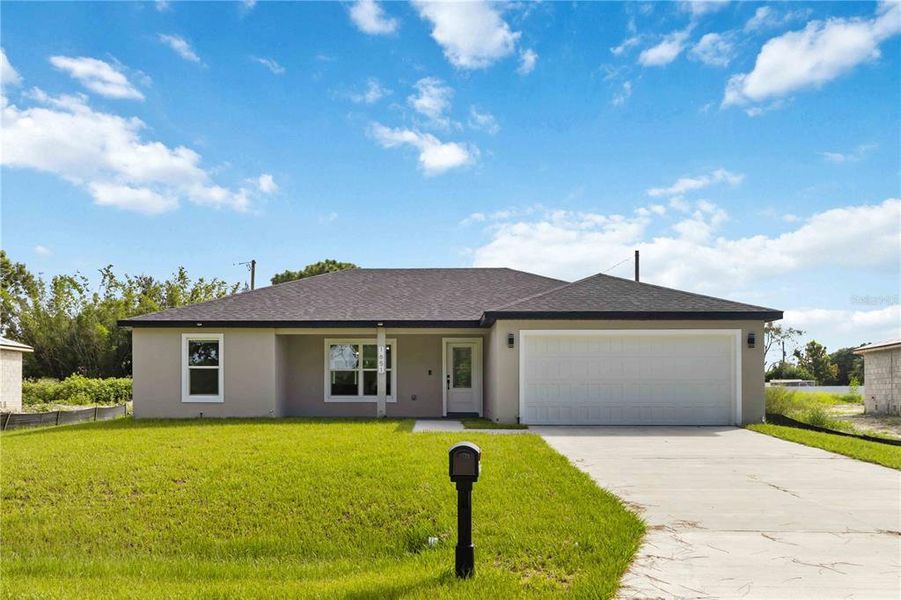 Front exterior of a new home in , Palm Bay, FL, highlighting curb appeal (Image 1).