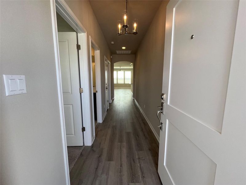 Smooth wood-look flooring guides the eye through this welcoming entryway toward the main living spaces. Smooth wood-look flooring guides the eye through this welcoming entryway toward the main living spaces.