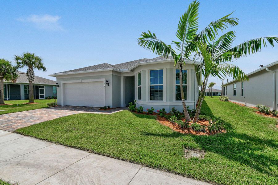 Front exterior of a new home in Del Webb Tradition, Port St. Lucie, FL, highlighting curb appeal (Image 1). Front exterior of a new home in Del Webb Tradition, Port St. Lucie, FL, highlighting curb appeal (Image 1).