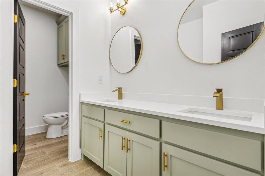 Full bath with double vanity and wood finish floors Full bath with double vanity and wood finish floors