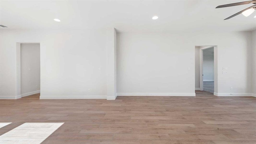 Empty room featuring ceiling fan and light hardwood / wood-style floors