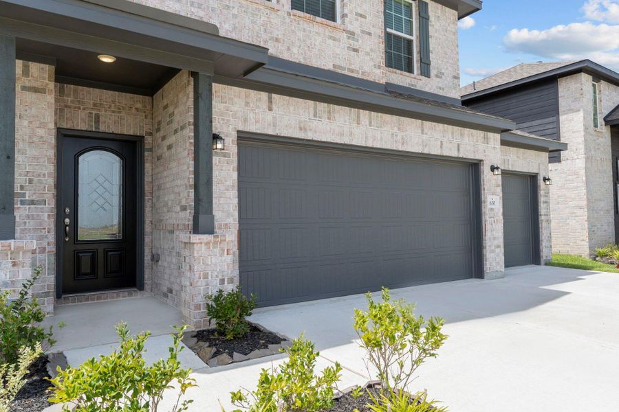 Inviting covered front entry with beautifully detailed brickwork and modern front door design. Make this your home — call now! Inviting covered front entry with beautifully detailed brickwork and modern front door design. Make this your home — call now!