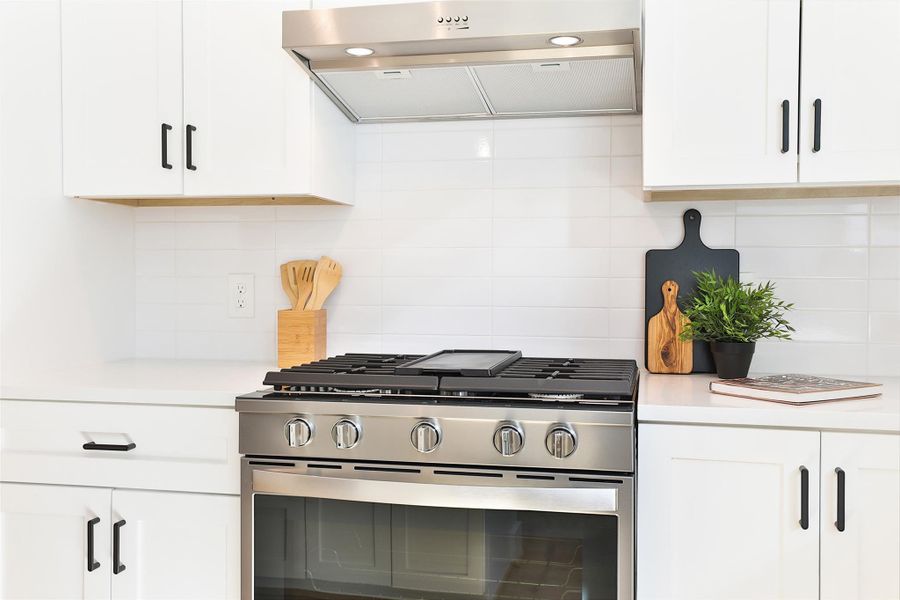 Equipped with stainless steel Whirlpool appliances and a gas range, this kitchen is every chef's dream.