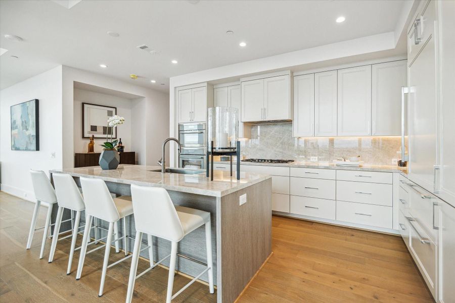 Center island features a built-in sink, and breakfast bar seating. Center island features a built-in sink, and breakfast bar seating.