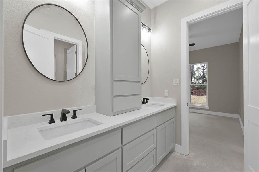 Secondary bathroom that connects the second and third bedroom with double sinks.