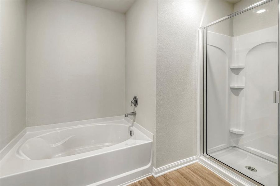 Check out the soaking tub and upgraded shower in the master bedroom!