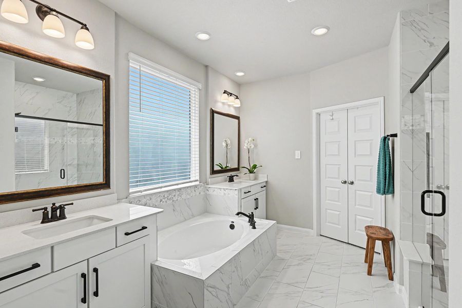 The primary bathroom features dual sinks, a walk-in shower, and a relaxing soaking tub. The primary bathroom features dual sinks, a walk-in shower, and a relaxing soaking tub.
