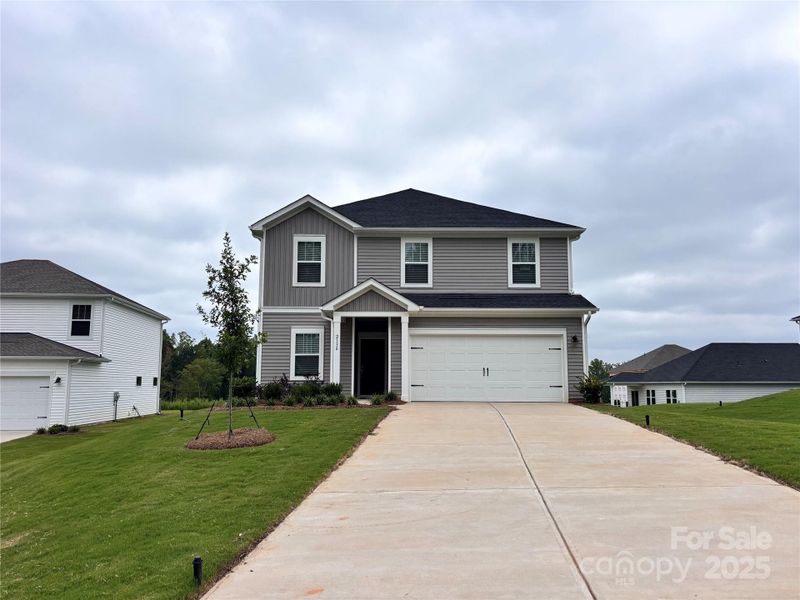 Front exterior of a new home in Harper Landing, Stanley, NC, highlighting curb appeal (Image 2). Front exterior of a new home in Harper Landing, Stanley, NC, highlighting curb appeal (Image 2).