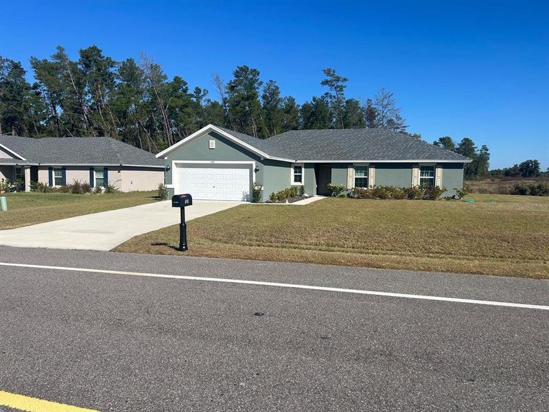 Front exterior of a new home in , Ocala, FL, highlighting curb appeal (Image 1).