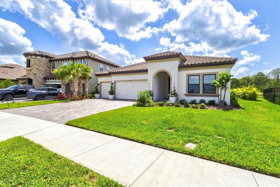 Front exterior of a new home in Crosswind Ranch, Parrish, FL, highlighting curb appeal (Image 29).